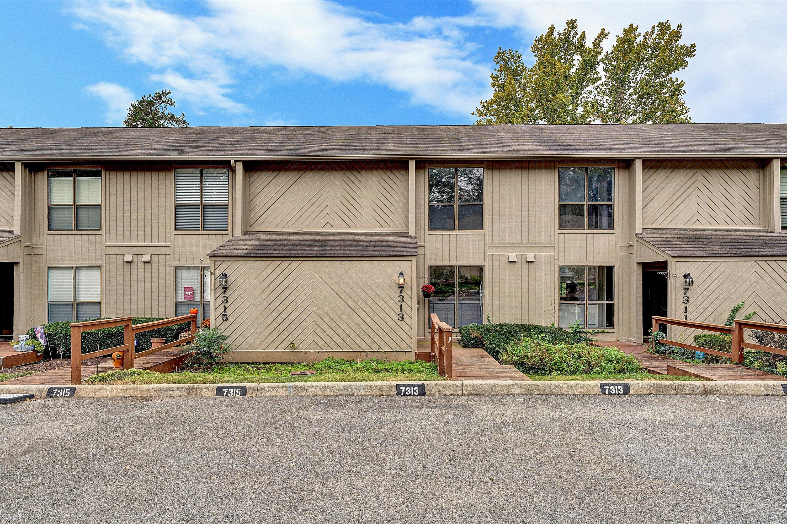7313 Maple Court Southwest Roanoke, VA 24018 - Photo 3 of 38 a front view of a house with a yard and garage