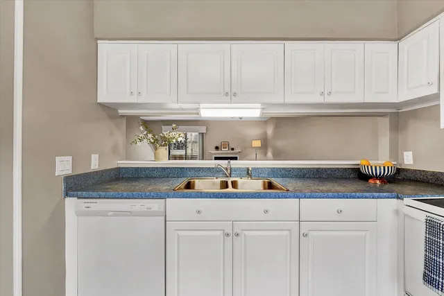 a kitchen with white cabinets and a sink