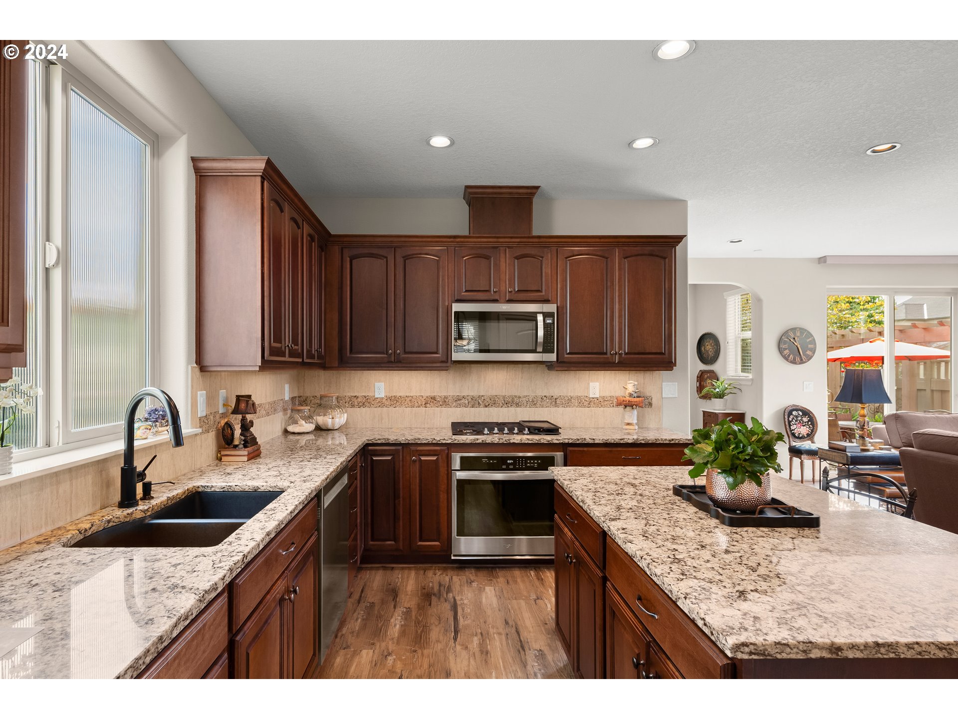 29190 Southwest Serenity Way Wilsonville, OR 97070 - Photo 11 of 40 a kitchen with kitchen island granite countertop a sink stove and cabinets