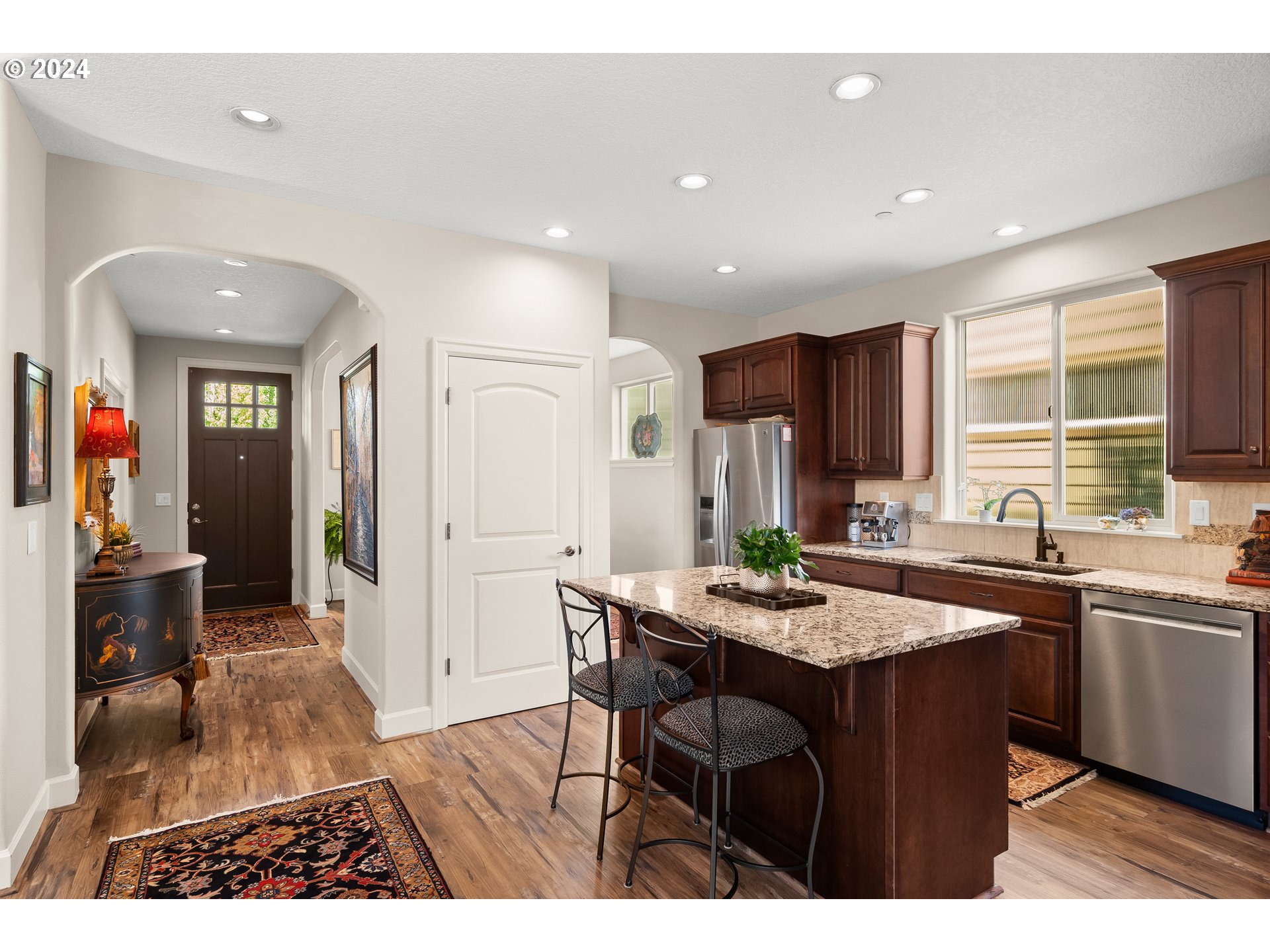 29190 Southwest Serenity Way Wilsonville, OR 97070 - Photo 13 of 40 a kitchen with stainless steel appliances granite countertop a sink and a refrigerator