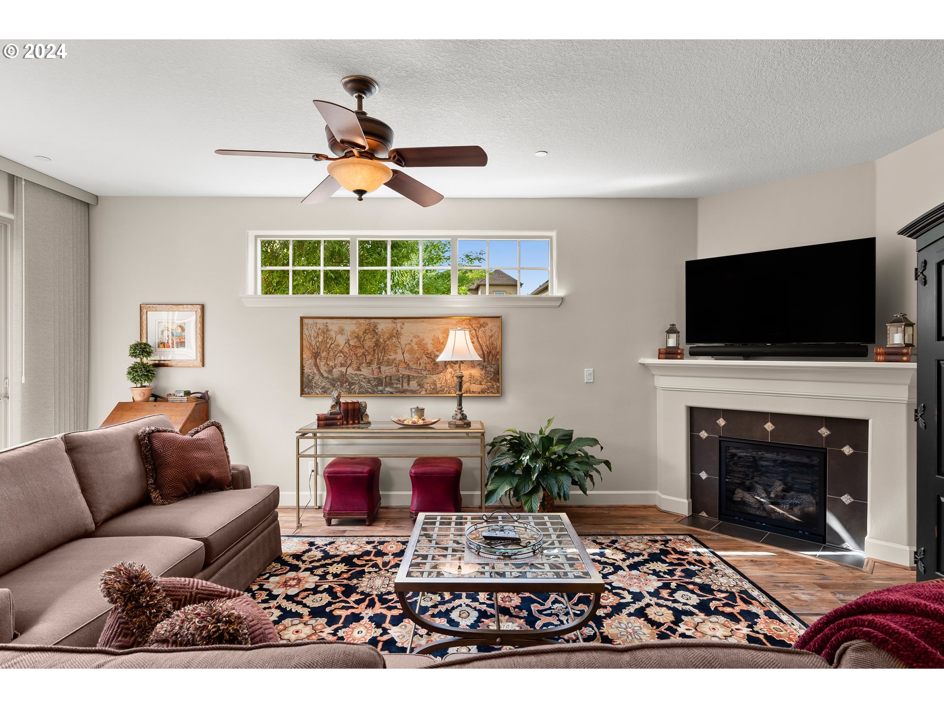 29190 Southwest Serenity Way Wilsonville, OR 97070 - Photo 15 of 40 a living room with furniture a fireplace and a flat screen tv