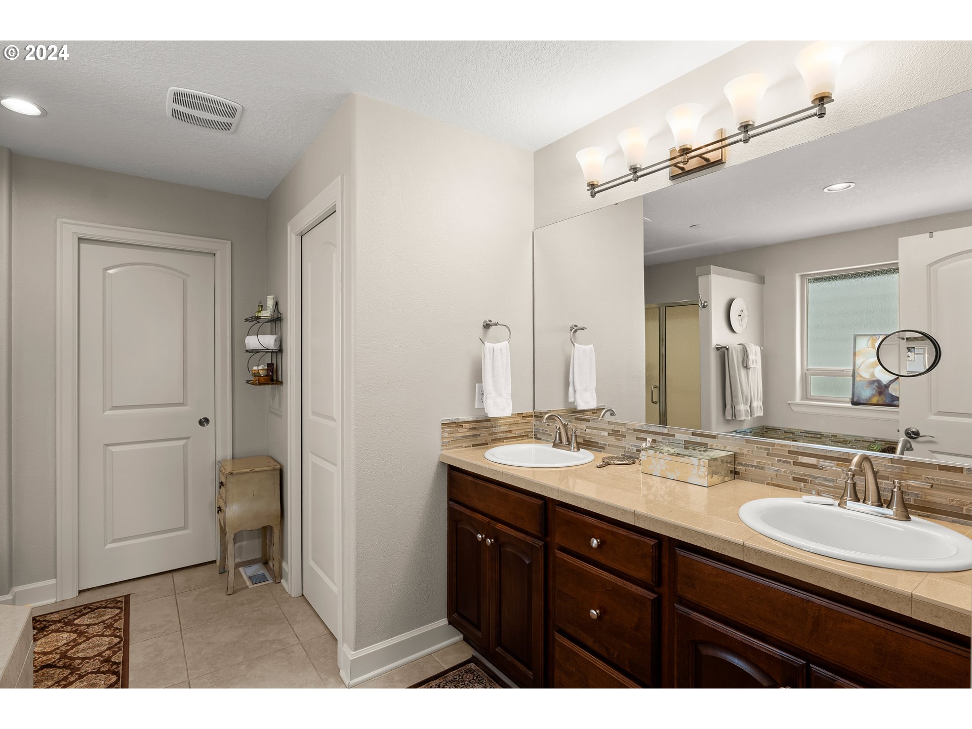 29190 Southwest Serenity Way Wilsonville, OR 97070 - Photo 18 of 40 a bathroom with a granite countertop sink a mirror and a