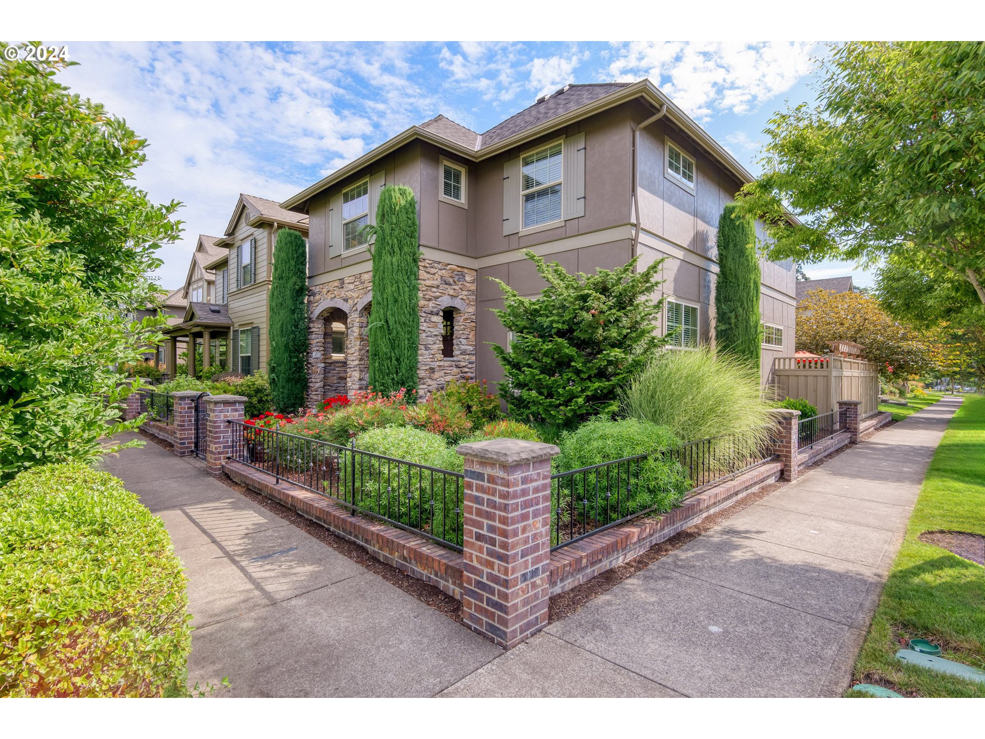 29190 Southwest Serenity Way Wilsonville, OR 97070 - Photo 2 of 40 a front view of a house with a garden and plants