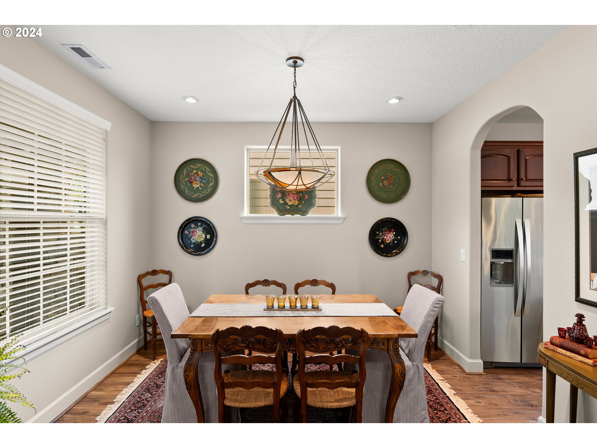 29190 Southwest Serenity Way Wilsonville, OR 97070 - Photo 7 of 40 a dining room with a wooden table a clock and a window