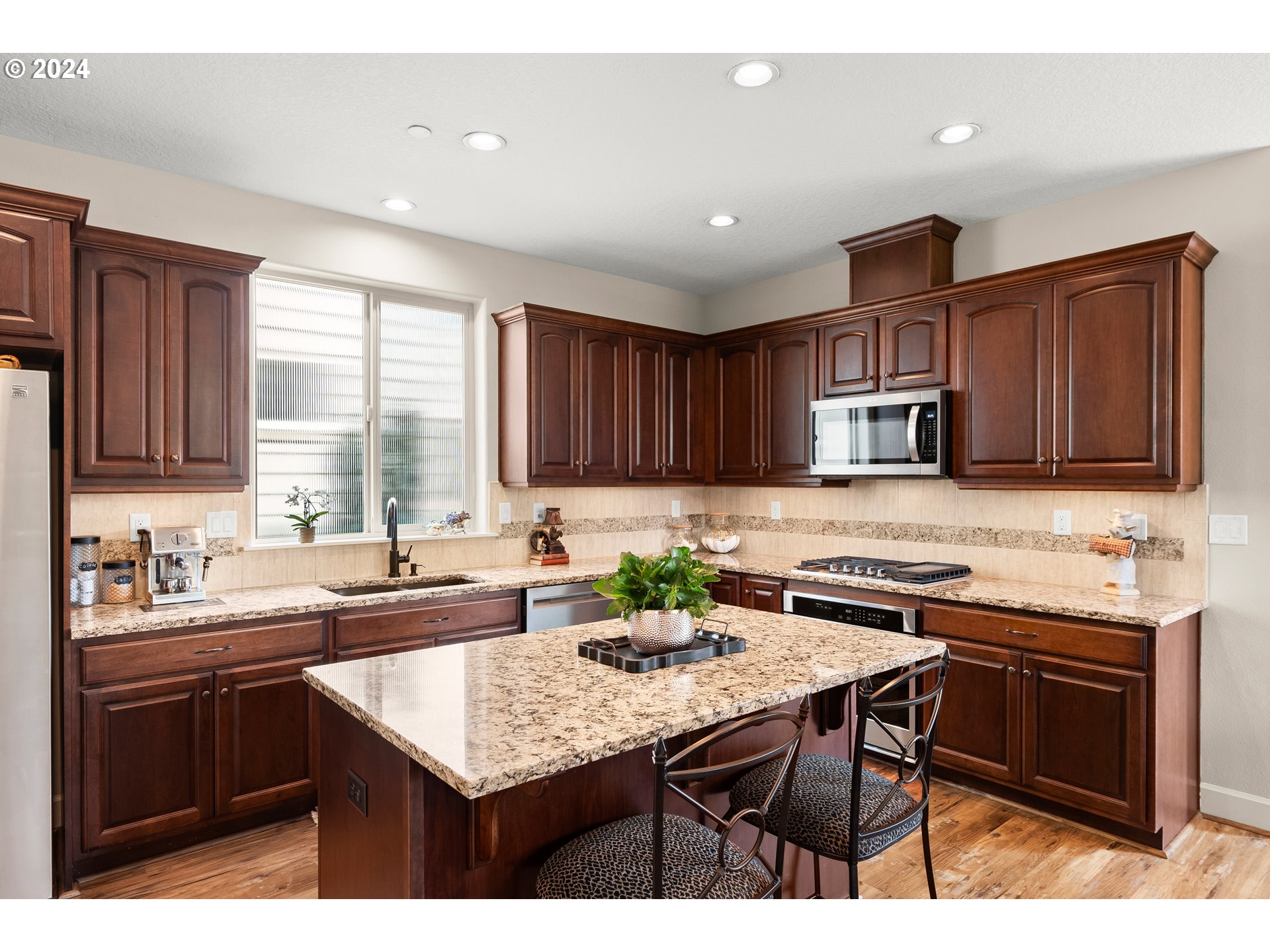 29190 Southwest Serenity Way Wilsonville, OR 97070 - Photo 10 of 40 a kitchen with granite countertop a sink and cabinets