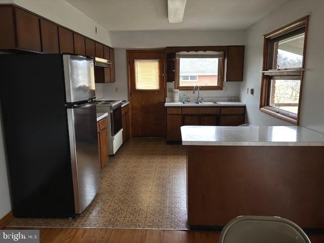 14804 Bell Street Southwest Cresaptown, MD 21502 - Photo 6 of 12 a kitchen with stainless steel appliances granite countertop a refrigerator a stove a sink and a microwave