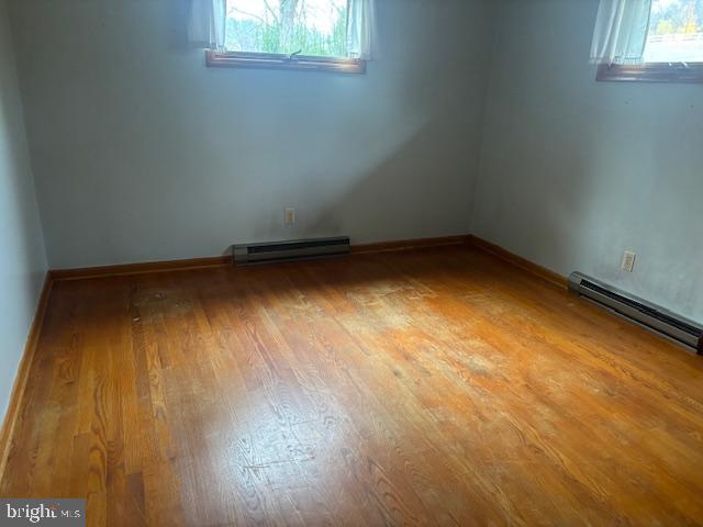 14804 Bell Street Southwest Cresaptown, MD 21502 - Photo 10 of 12 an empty room with wooden floor and windows