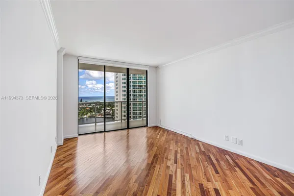 a view of a room with wooden floor
