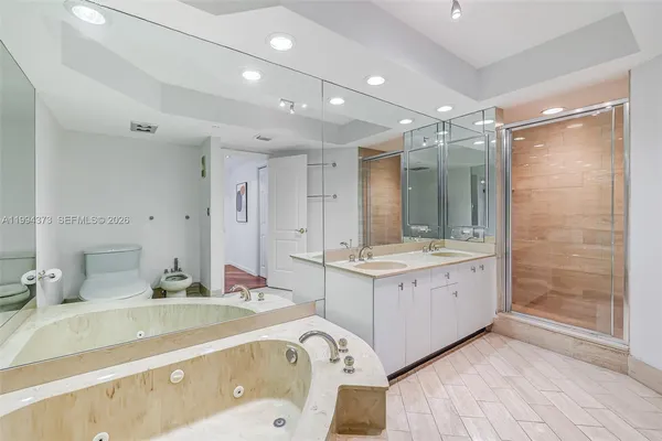 a bathroom with a shower sink and mirror