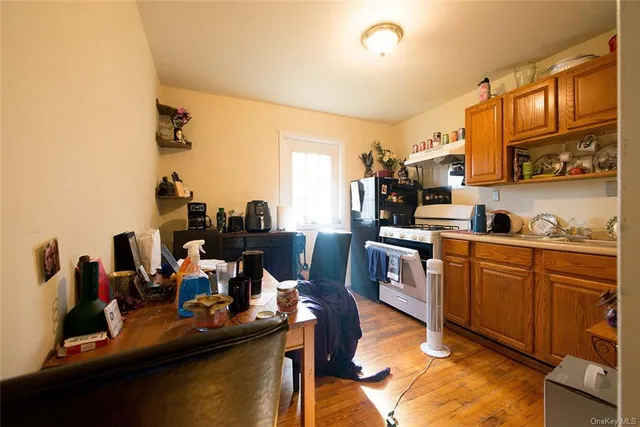 a kitchen with a table chairs refrigerator and microwave