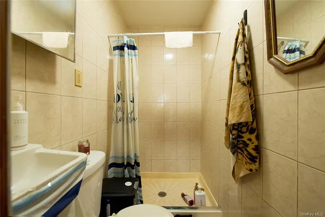 a bathroom with a tub a sink and shower