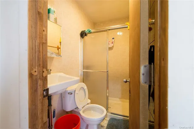 a bathroom with a toilet and a shower