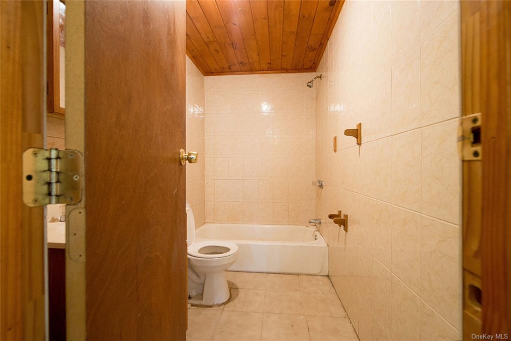 304 Wade Road Liberty, NY 12754 - Photo 6 of 35 a bathroom with a toilet and shower
