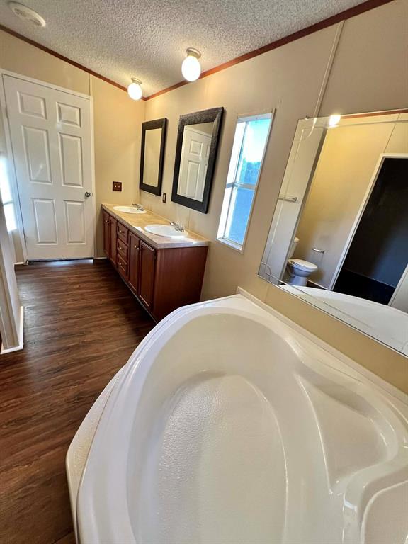 1085 Highland Circle Springtown, TX 76082 - Photo 12 of 30 a spacious bedroom with two beds and a table