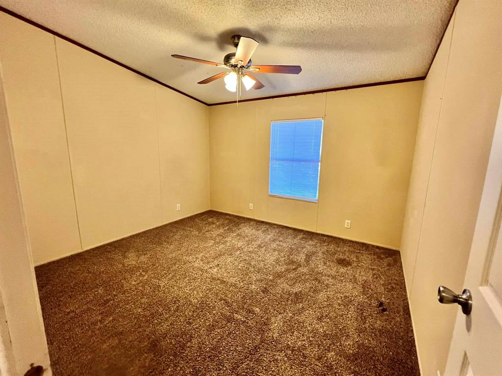 1085 Highland Circle Springtown, TX 76082 - Photo 15 of 30 a view of a room with a ceiling fan and wooden floor