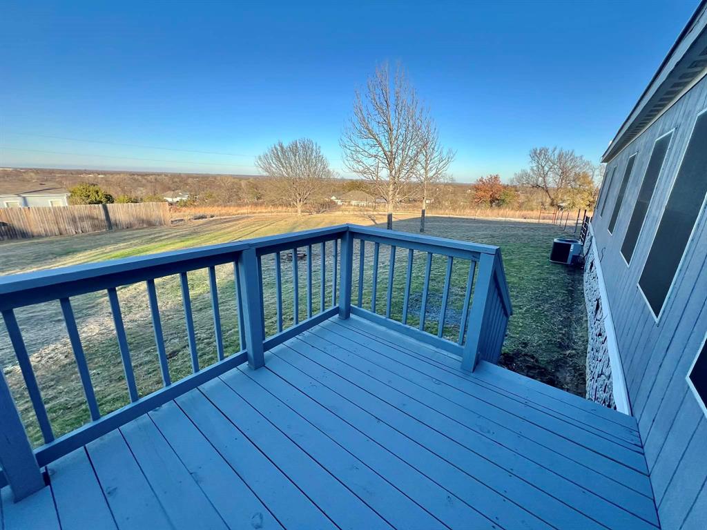 1085 Highland Circle Springtown, TX 76082 - Photo 21 of 30 a view of a balcony with wooden floor