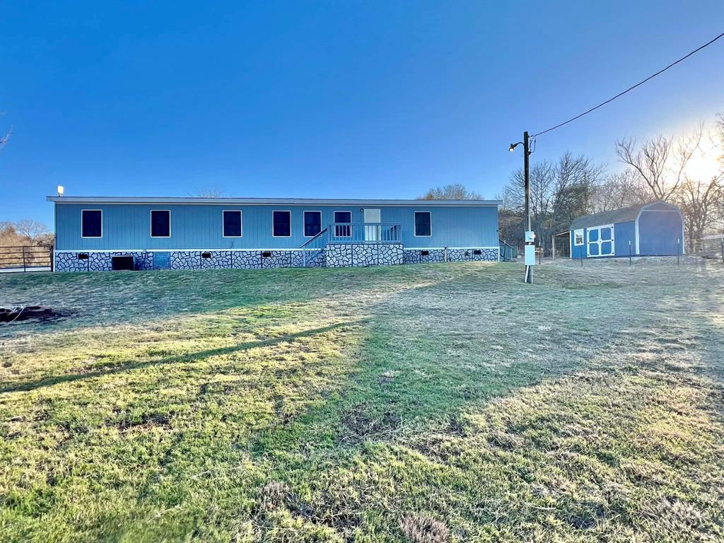 1085 Highland Circle Springtown, TX 76082 - Photo 22 of 30 a view of a house with a yard