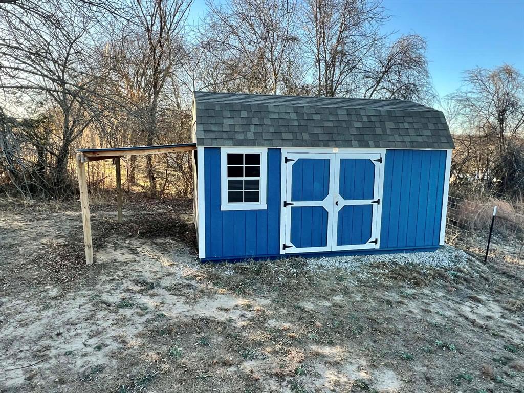 1085 Highland Circle Springtown, TX 76082 - Photo 23 of 30 a front view of a house with garden
