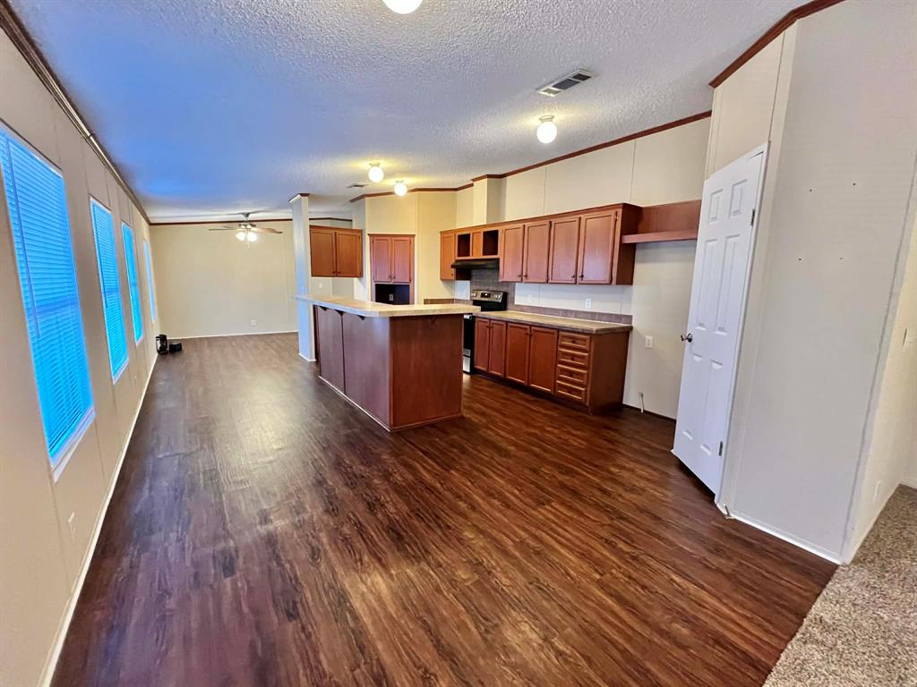 1085 Highland Circle Springtown, TX 76082 - Photo 8 of 30 a view of kitchen with wooden floor and electronic appliances