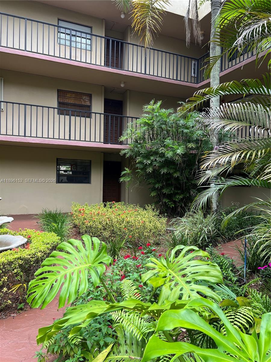10855 Southwest 112th Avenue, Unit 215 Miami, FL 33176 - Photo 18 of 45 a front view of a house with a garden