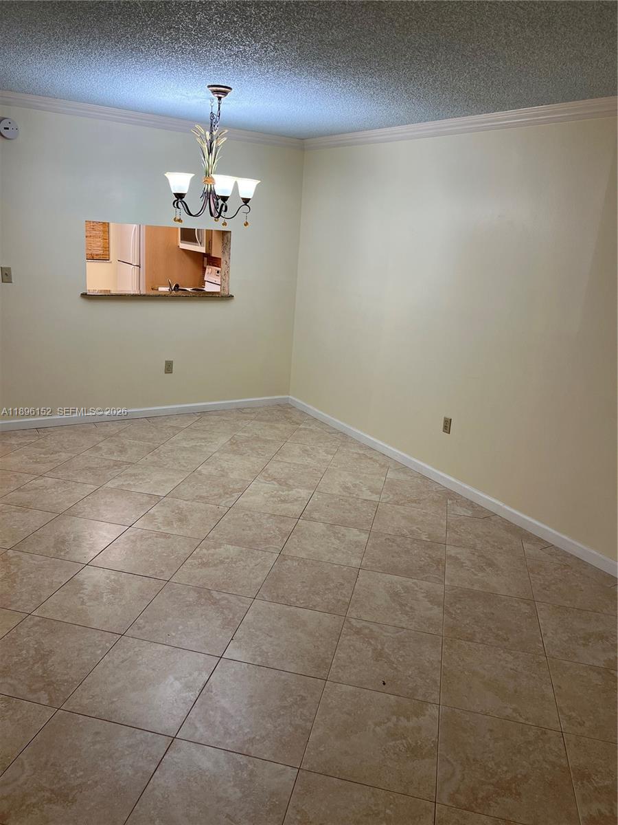 10855 Southwest 112th Avenue, Unit 215 Miami, FL 33176 - Photo 23 of 45 a view of a kitchen with a stove a chandelier fan and windows