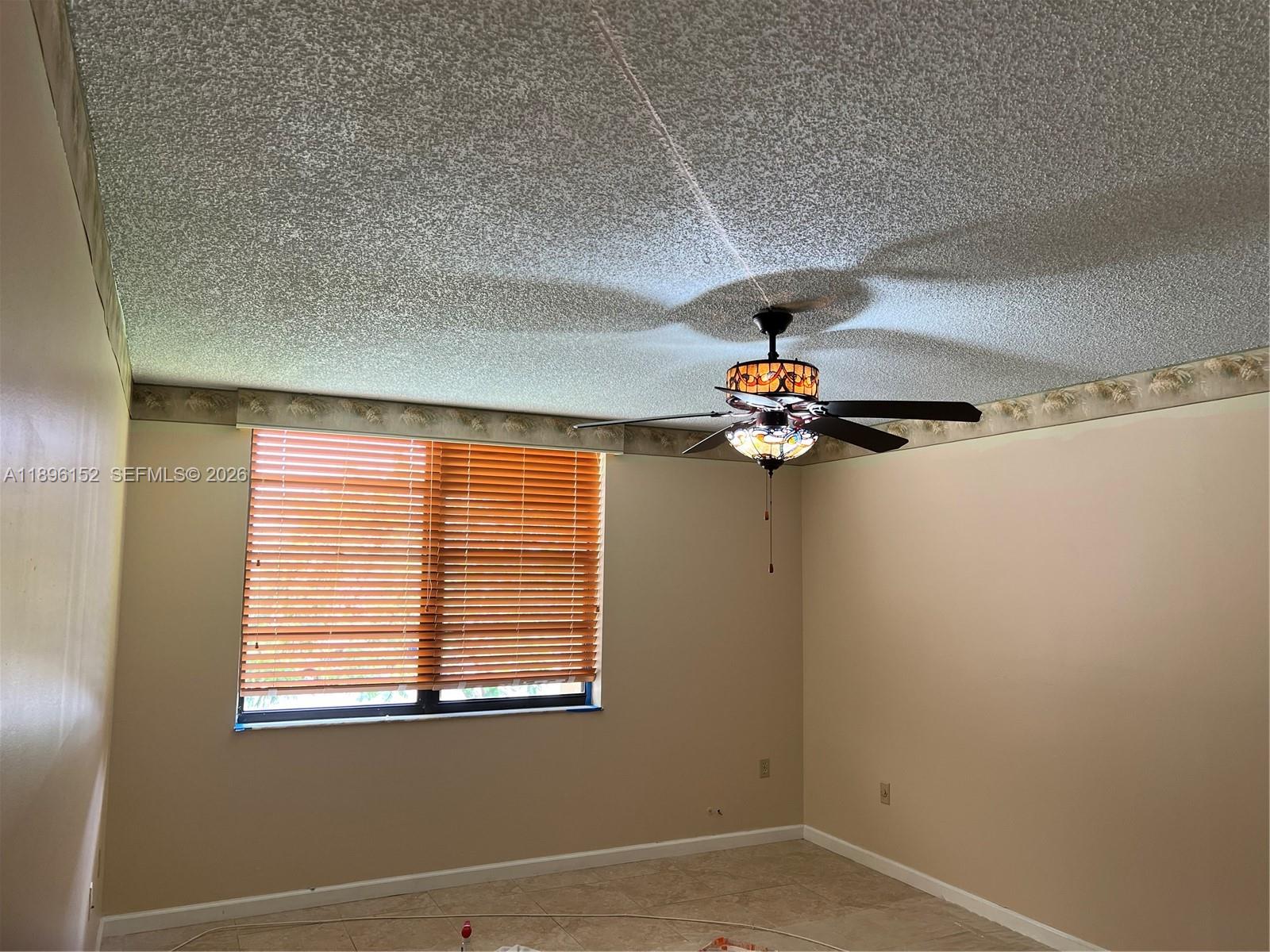 10855 Southwest 112th Avenue, Unit 215 Miami, FL 33176 - Photo 27 of 45 a view of wooden floor and a chandelier fan in a room