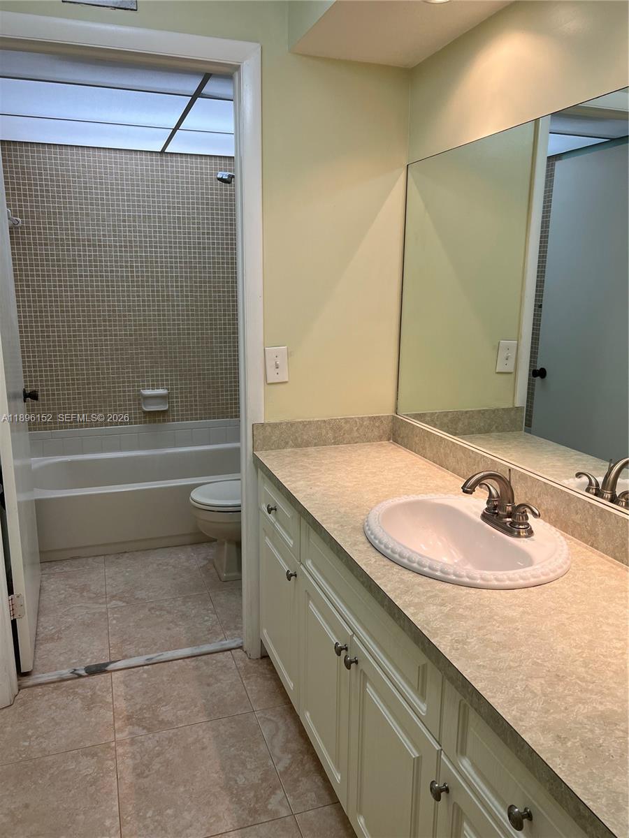 10855 Southwest 112th Avenue, Unit 215 Miami, FL 33176 - Photo 28 of 45 a bathroom with a granite countertop sink and a mirror