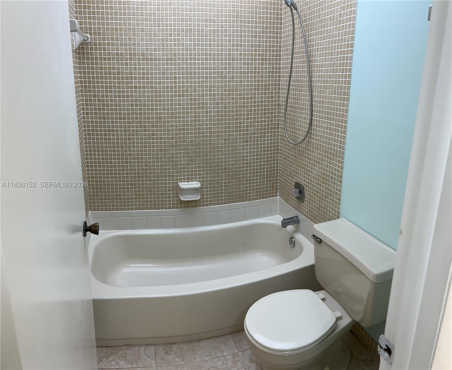 10855 Southwest 112th Avenue, Unit 215 Miami, FL 33176 - Photo 29 of 45 a white toilet sitting next to a bath tub