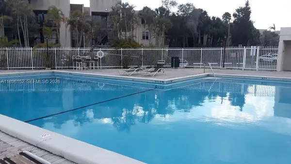 a view of swimming pool with outdoor seating and yard