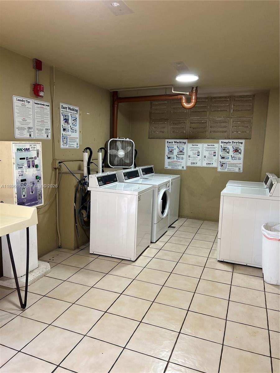 10855 Southwest 112th Avenue, Unit 215 Miami, FL 33176 - Photo 39 of 45 a kitchen with a stove top oven cabinets and utility