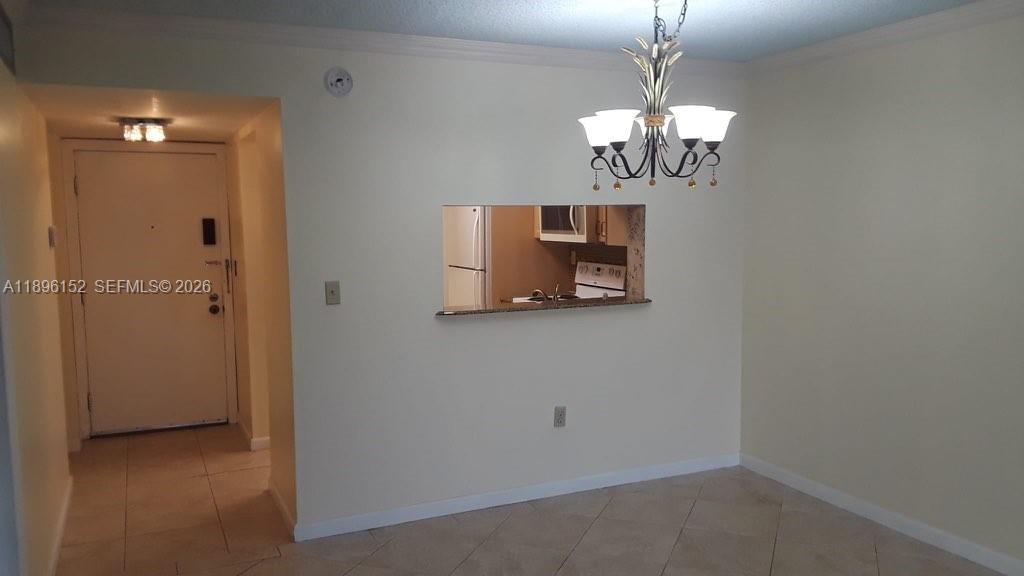 10855 Southwest 112th Avenue, Unit 215 Miami, FL 33176 - Photo 40 of 45 a room with window and a chandelier