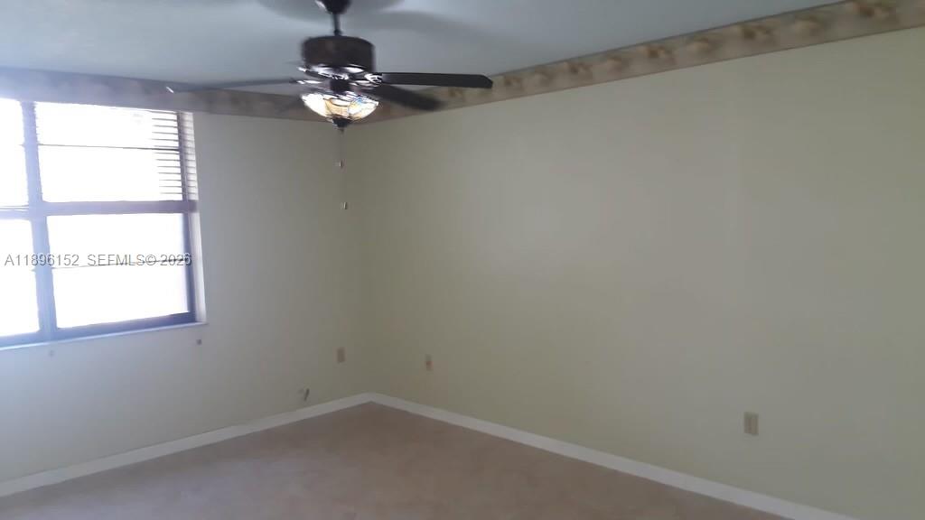 10855 Southwest 112th Avenue, Unit 215 Miami, FL 33176 - Photo 42 of 45 an empty room with a window