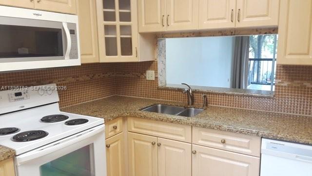 10855 Southwest 112th Avenue, Unit 215 Miami, FL 33176 - Photo 45 of 45 a kitchen with a sink a stove and cabinets