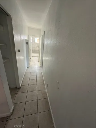 an empty room with white walls and tiles
