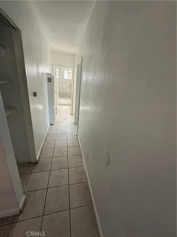 an empty room with white walls and tiles