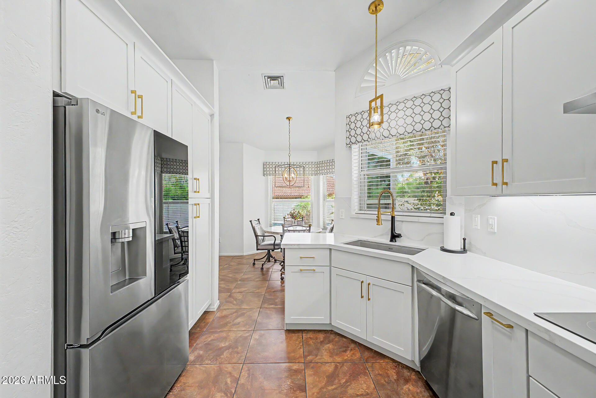 1924 East El Freda Road Tempe, AZ 85284 - Photo 9 of 56 a kitchen with a sink a refrigerator and window