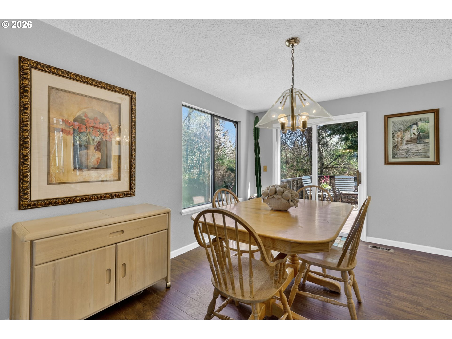 21155 Southeast Foster Road Damascus, OR 97089 - Photo 12 of 48 a dining room with furniture a chandelier and wooden floor