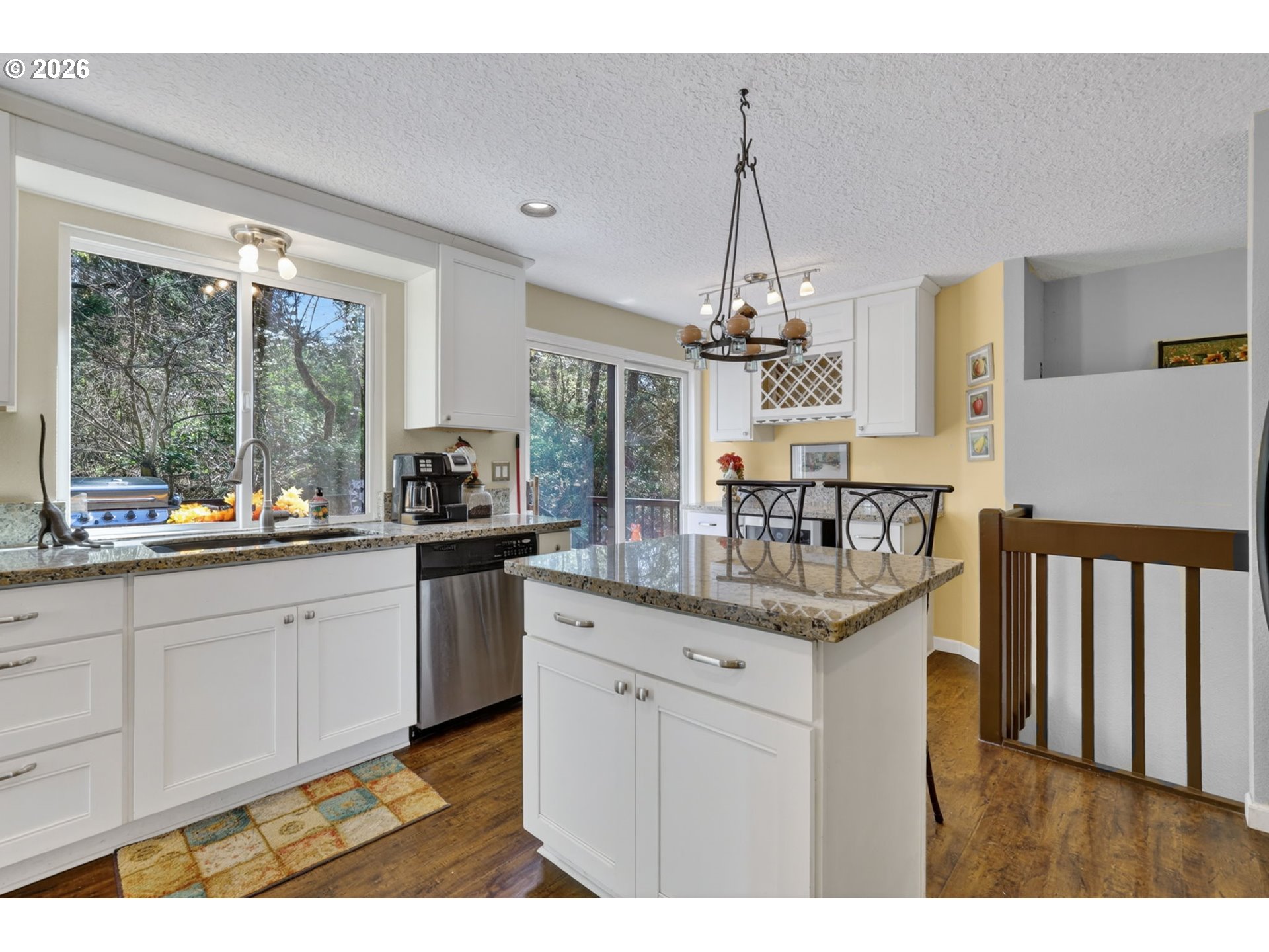 21155 Southeast Foster Road Damascus, OR 97089 - Photo 15 of 48 a kitchen with granite countertop a sink cabinets and wooden floor