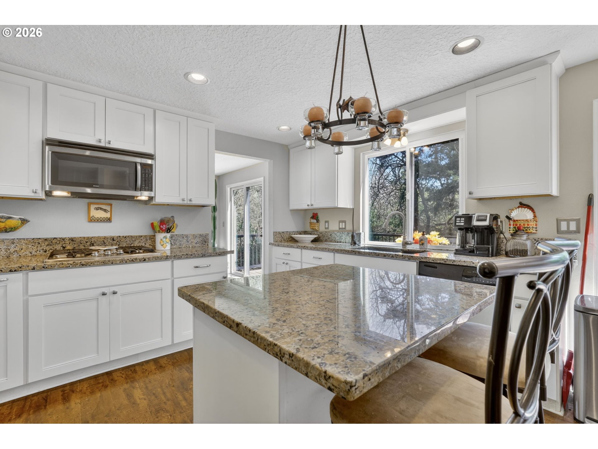 21155 Southeast Foster Road Damascus, OR 97089 - Photo 19 of 48 a kitchen with stainless steel appliances granite countertop a sink refrigerator stove and microwave