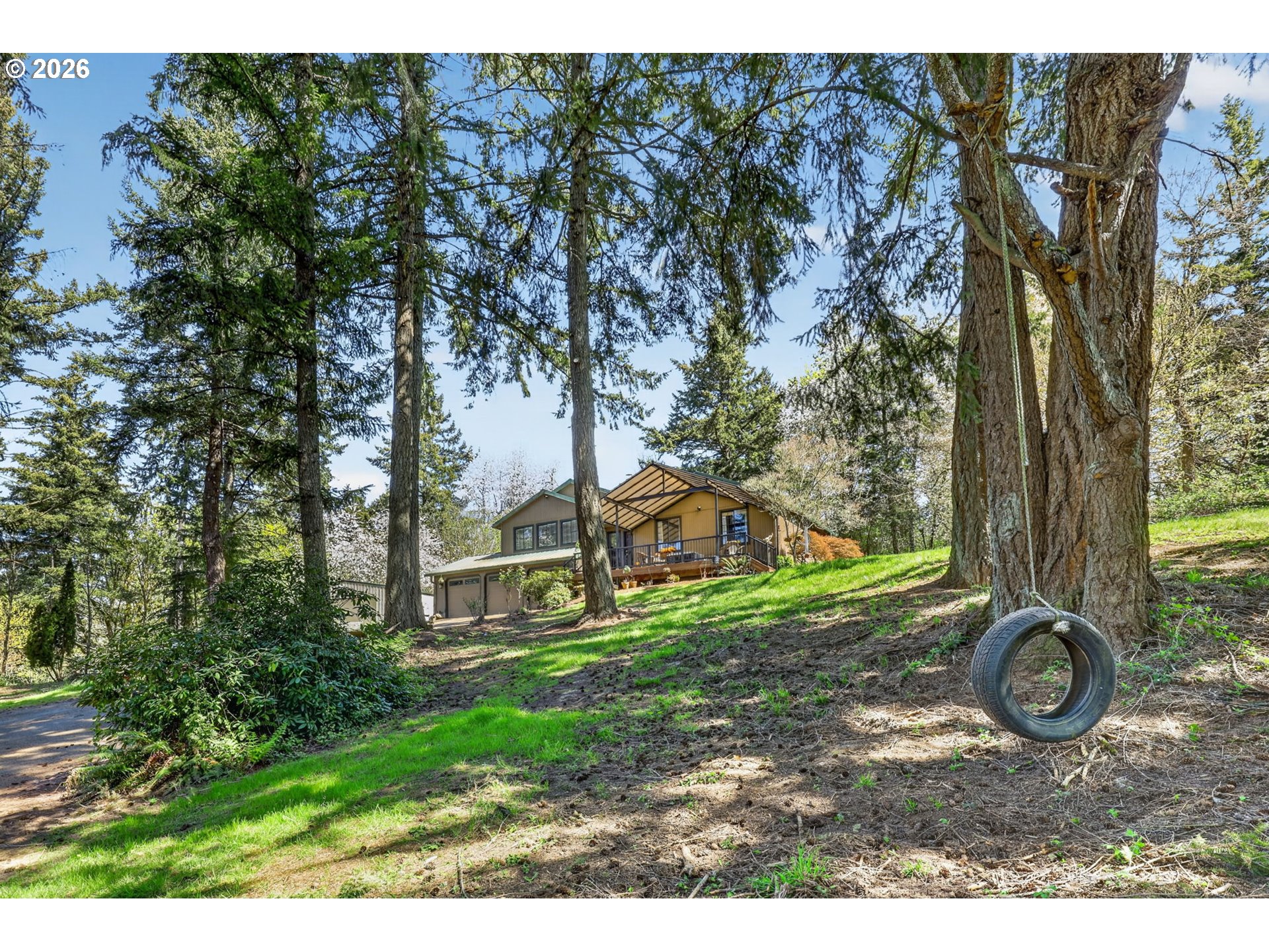 21155 Southeast Foster Road Damascus, OR 97089 - Photo 4 of 48 a view of a backyard with plants and large trees
