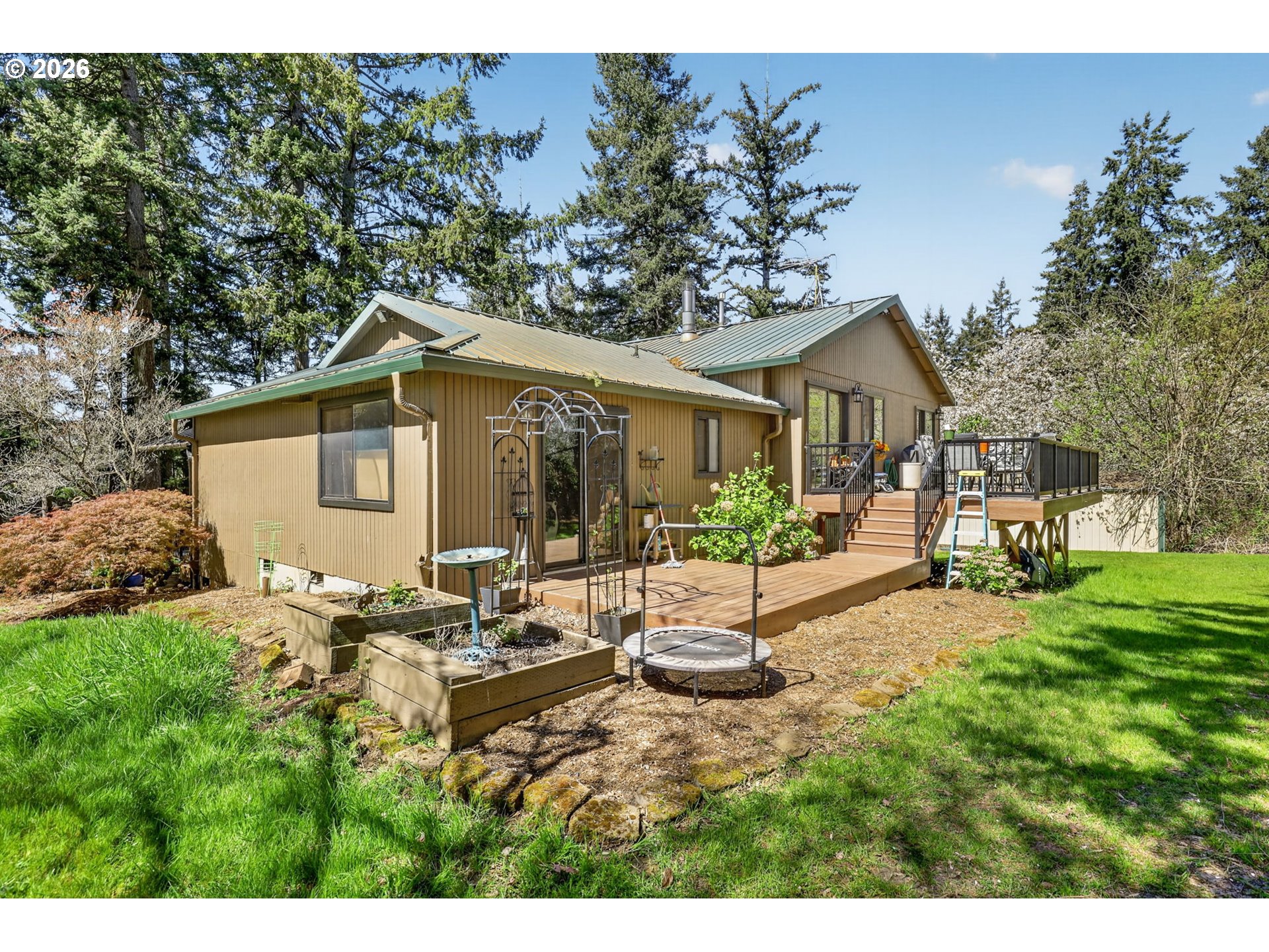 21155 Southeast Foster Road Damascus, OR 97089 - Photo 44 of 48 a view of a house with backyard sitting area and garden