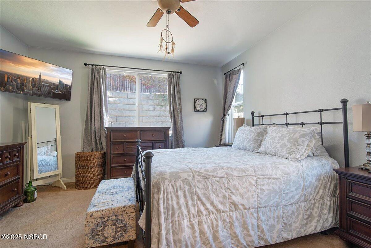 561 Andromeda Drive Lompoc, CA 93436 - Photo 27 of 54 a bedroom with a bed and wooden floor