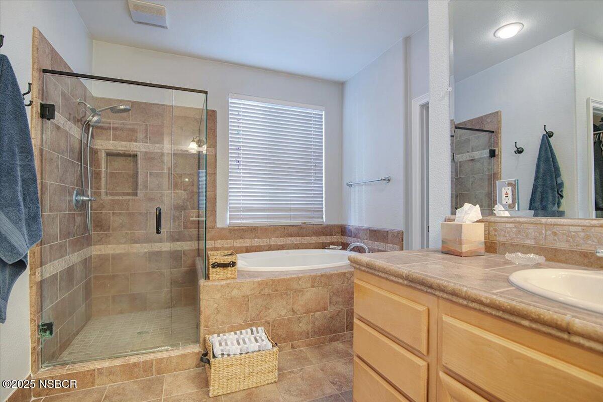 561 Andromeda Drive Lompoc, CA 93436 - Photo 30 of 54 a bathroom with a granite countertop sink mirror and shower