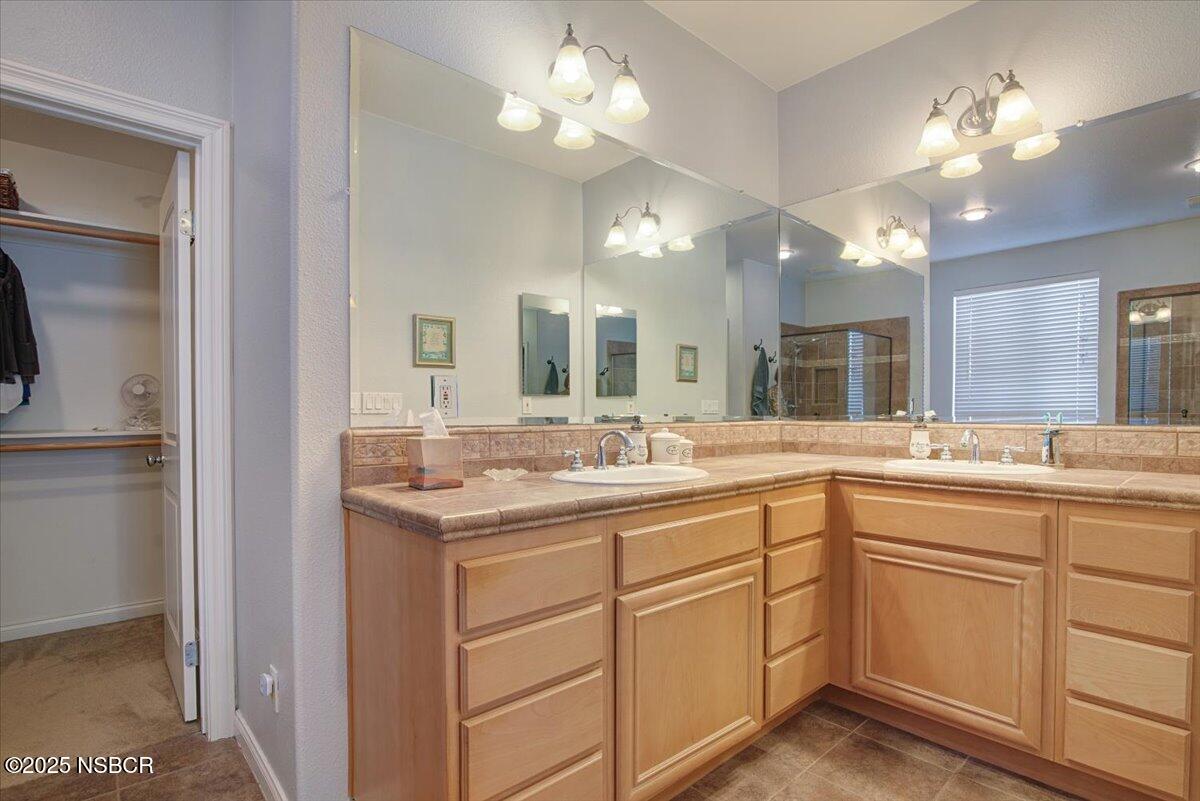 561 Andromeda Drive Lompoc, CA 93436 - Photo 31 of 54 a bathroom with a sink vanity and a mirror