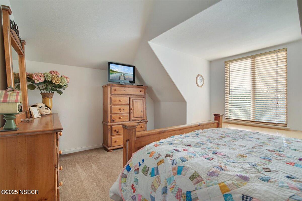 561 Andromeda Drive Lompoc, CA 93436 - Photo 40 of 54 a bedroom with a bed and a dresser in it