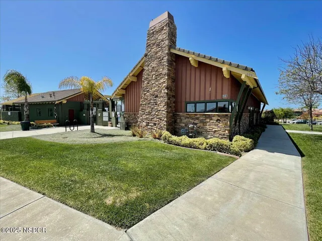 a view of a house with backyard porch and sitting area