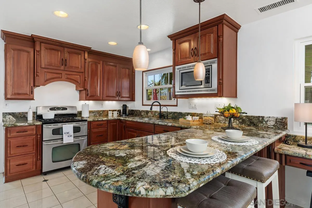 2016 Sequoia Street San Marcos, CA 92078 - Photo 18 of 50 a large kitchen with sink a stove and cabinets