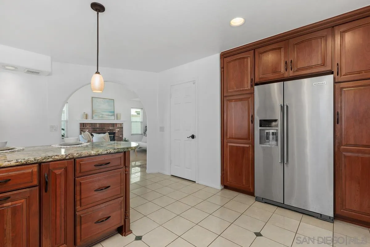 2016 Sequoia Street San Marcos, CA 92078 - Photo 20 of 50 a kitchen with granite countertop stainless steel appliances a refrigerator and a sink