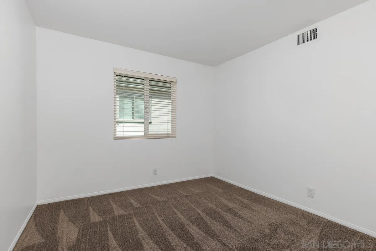 2016 Sequoia Street San Marcos, CA 92078 - Photo 31 of 50 a view of an empty room with wooden floor and a window
