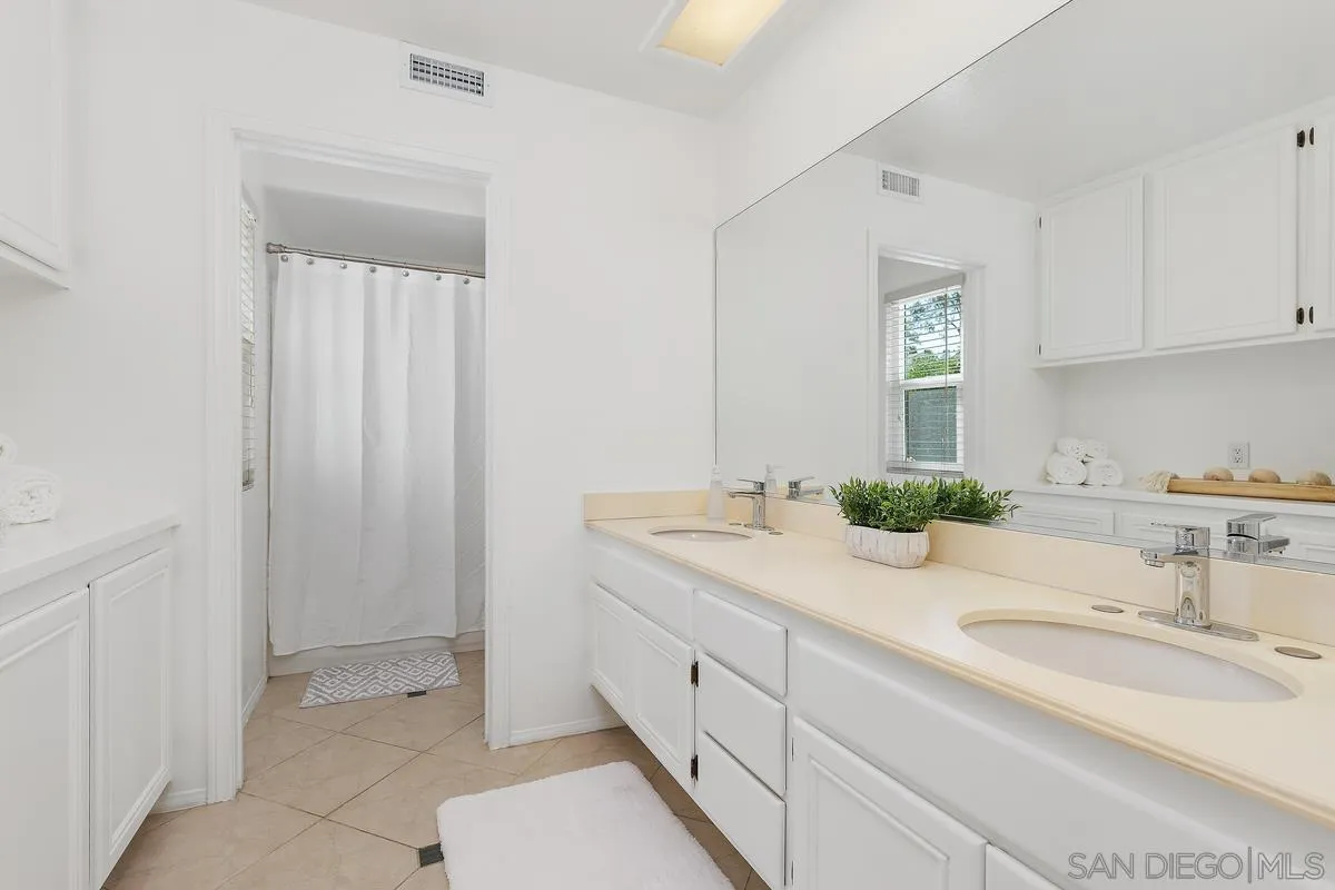 2016 Sequoia Street San Marcos, CA 92078 - Photo 32 of 50 a spacious bathroom with a granite countertop sink and a mirror
